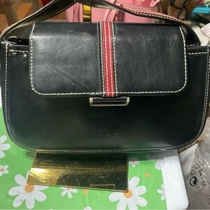 The Kate Spade crossbody bag has loose stitching on top.